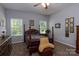 Cozy bedroom featuring a four-poster bed, neutral walls, and natural light from two windows at 602 Black Maple Dr, Kannapolis, NC 28081