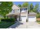Charming two-story home with a well-manicured lawn, a two-car garage, and stone accents at 602 Black Maple Dr, Kannapolis, NC 28081