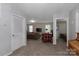 Open-concept living room with neutral walls, and carpeted floors with doorways to other rooms at 602 Black Maple Dr, Kannapolis, NC 28081