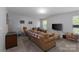 Comfortable living room featuring a large couch, carpeted floors, a TV, and natural light at 602 Black Maple Dr, Kannapolis, NC 28081