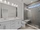 Modern bathroom with double vanity, large mirror, and glass shower at 655 District Ct, Fort Mill, SC 29708