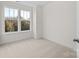 The bedroom is filled with light from two windows and is carpeted at 655 District Ct, Fort Mill, SC 29708