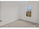 This bedroom has neutral carpeting and a window for natural light at 655 District Ct, Fort Mill, SC 29708
