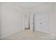 A bedroom featuring neutral carpeting and double doors for ample closet space at 655 District Ct, Fort Mill, SC 29708