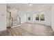 Bright living room features wood floors, natural light, and staircase access to an upper level at 655 District Ct, Fort Mill, SC 29708