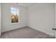 Neutral carpeted bedroom with a window overlooking the trees and foliage at 657 District Ct, Fort Mill, SC 29708