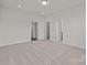 Spacious bedroom with neutral carpet, double doors to closet, and bright white trim at 657 District Ct, Fort Mill, SC 29708