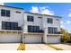 Modern townhome exterior with white siding, black trim and windows, and garage at 657 District Ct, Fort Mill, SC 29708