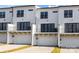 Modern townhome with white siding, black windows, second story balcony, and two-car garage at 657 District Ct, Fort Mill, SC 29708