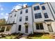 Charming, newly built townhome featuring a modern white facade and well-manicured landscaping at 657 District Ct, Fort Mill, SC 29708