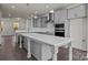 Bright kitchen with a large center island, gray cabinets, stainless steel appliances, and stylish pendant lighting at 657 District Ct, Fort Mill, SC 29708