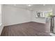 Spacious living room with hardwood floors and a partial view of the kitchen and staircase at 657 District Ct, Fort Mill, SC 29708