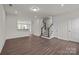 Bright living room featuring hardwood floors, a staircase, and a view of the kitchen at 657 District Ct, Fort Mill, SC 29708