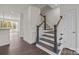 Bright foyer featuring a staircase with wood treads, white risers and gray newel posts at 657 District Ct, Fort Mill, SC 29708