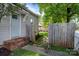 Back entrance with brick steps, fenced backyard, and brick paver walkway at 700 Oakland Ave, Charlotte, NC 28204