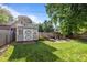 Fenced backyard with shed, fire pit, and wooden picnic table at 700 Oakland Ave, Charlotte, NC 28204