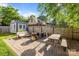 Beautiful backyard has a patio with an outdoor kitchen, sitting area, and dining at 700 Oakland Ave, Charlotte, NC 28204