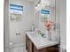 Bright bathroom featuring vanity with sink, fresh flowers, and ample natural light at 700 Oakland Ave, Charlotte, NC 28204