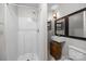 Bathroom featuring a stand-up shower, modern sink, and decorative mirror at 700 Oakland Ave, Charlotte, NC 28204