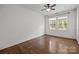 Bright bedroom featuring hardwood floors, ceiling fan, and natural light from windows at 700 Oakland Ave, Charlotte, NC 28204