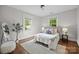 Cozy bedroom with natural light from two windows, plus an accent rug at 700 Oakland Ave, Charlotte, NC 28204