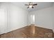 Neutral bedroom featuring hardwood floors and ceiling fan with a doorway to the adjoining room at 700 Oakland Ave, Charlotte, NC 28204