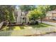 Charming home with brick walkway, white picket fence, well-manicured lawn, and mature landscaping under a bright blue sky at 700 Oakland Ave, Charlotte, NC 28204