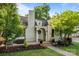 Charming home with brick walkway, front porch, well-manicured lawn, and mature landscaping under a bright blue sky at 700 Oakland Ave, Charlotte, NC 28204