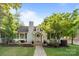 Charming home with brick walkway, front porch, well-manicured lawn, and mature landscaping under a bright blue sky at 700 Oakland Ave, Charlotte, NC 28204