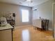 Well-lit bedroom features hardwood floors, a ceiling fan, and ample space for a variety of uses at 788 N Main St, Mount Pleasant, NC 28124