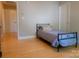 Cozy bedroom with wood floors and a minimalist metal bed frame with doors leading to other rooms at 788 N Main St, Mount Pleasant, NC 28124