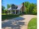 Charming craftsman home with metal roof, covered front porch with white columns, and well-maintained lawn at 788 N Main St, Mount Pleasant, NC 28124