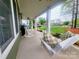 Inviting front porch features a comfortable swing and rocking chairs, perfect for relaxing and enjoying the neighborhood view at 788 N Main St, Mount Pleasant, NC 28124