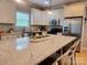 Well-appointed kitchen features granite countertops, stainless steel appliances, and a large island for food preparation and casual dining at 788 N Main St, Mount Pleasant, NC 28124