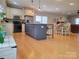 Spacious kitchen with a large center island, modern appliances, hardwood floors, and ample space for dining and entertaining at 788 N Main St, Mount Pleasant, NC 28124
