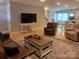Cozy living room features hardwood floors, comfortable seating, and seamless flow to the dining area at 788 N Main St, Mount Pleasant, NC 28124