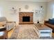 Comfortable living area highlighting a brick fireplace, hardwood floors, and stylish decor elements at 788 N Main St, Mount Pleasant, NC 28124