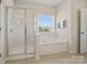 Bright bathroom featuring a tub, a shower, neutral tile floors and a window with blinds at 79411 Ridgehaven Rd, Indian Land, SC 29720