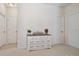 Bedroom with a white dresser featuring decorative accents and three doors in the background at 79411 Ridgehaven Rd, Indian Land, SC 29720