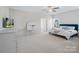 Spacious bedroom with a king bed, a tv, a vanity and a bathroom in the background at 79411 Ridgehaven Rd, Indian Land, SC 29720