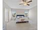 Bright bedroom featuring a bed with blue accents, a ceiling fan and lots of natural light at 79411 Ridgehaven Rd, Indian Land, SC 29720