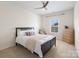 Cozy bedroom with a ceiling fan, natural light, and a bed with decorative pillows and blanket at 79411 Ridgehaven Rd, Indian Land, SC 29720