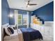 Blue-walled bedroom featuring a queen bed, natural light, a ceiling fan, and built in shelving at 79411 Ridgehaven Rd, Indian Land, SC 29720