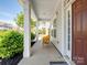 Inviting front porch featuring a cozy wicker chair and stylish exterior finishes at 79411 Ridgehaven Rd, Indian Land, SC 29720