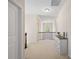 Hallway with white walls, neutral carpet, dark wood railing and a white dresser with decor at 79411 Ridgehaven Rd, Indian Land, SC 29720