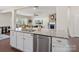 Spacious kitchen island with stainless steel dishwasher, sink, and granite countertops offers a modern look at 79411 Ridgehaven Rd, Indian Land, SC 29720