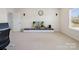 Bright living room boasts neutral walls, carpet flooring, media center, and a serene atmosphere at 79411 Ridgehaven Rd, Indian Land, SC 29720