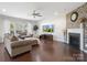 Inviting living room with a fireplace, brick accent wall, and hardwood floors at 79411 Ridgehaven Rd, Indian Land, SC 29720