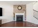 Cozy living room with brick accent wall, fireplace, and hardwood floors at 79411 Ridgehaven Rd, Indian Land, SC 29720