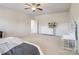 Spacious main bedroom featuring a ceiling fan, dresser, and illuminated vanity at 79411 Ridgehaven Rd, Indian Land, SC 29720